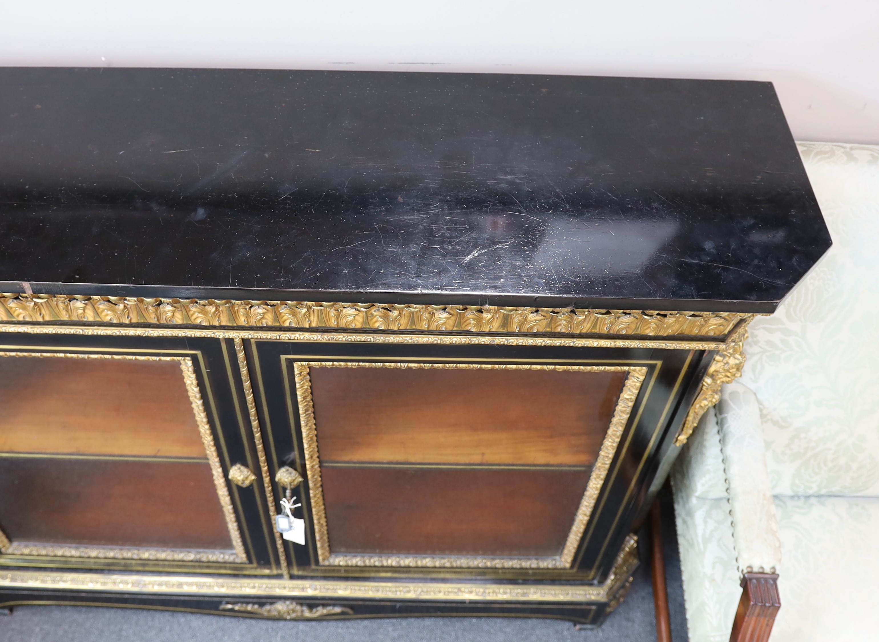 A 19th century French gilt metal mounted ebonised two door side cabinet, width 140cm, depth 38cm, height 107cm